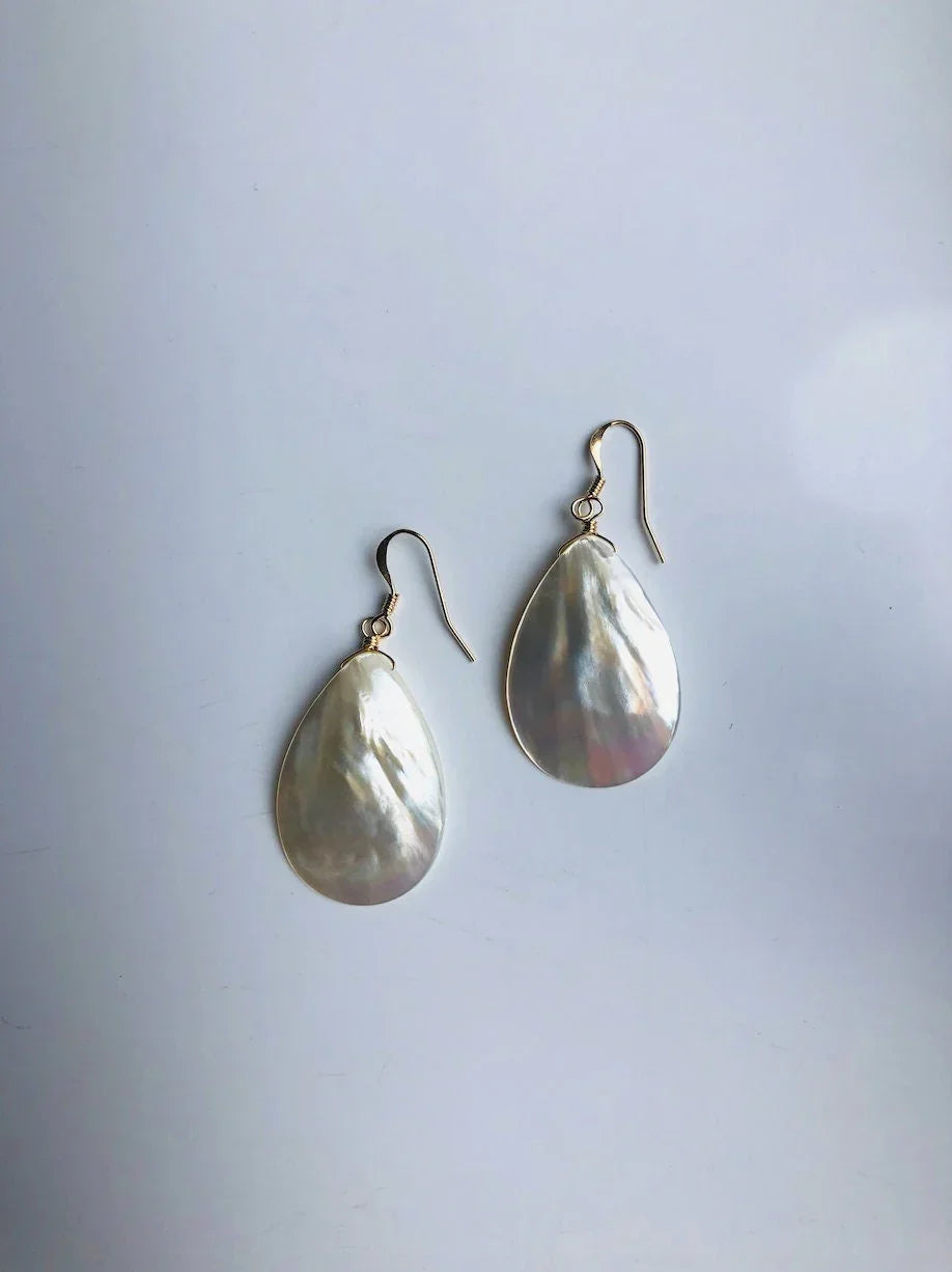 Pair of teardrop-shaped earrings on a light gray background