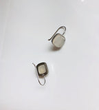 back view of white jade square dangle earrings hanging from polished 990 silver hooks
