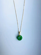 Front view of dainty green jade donut pendant on minimalist 16" chain