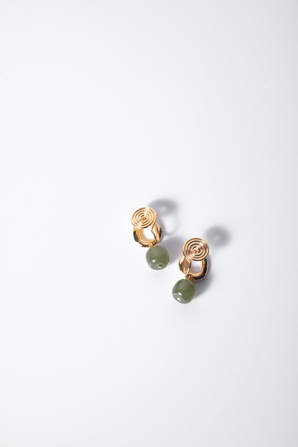 Close-up of genuine green jade clip-on earrings showing green jade earrings and gold clips detail