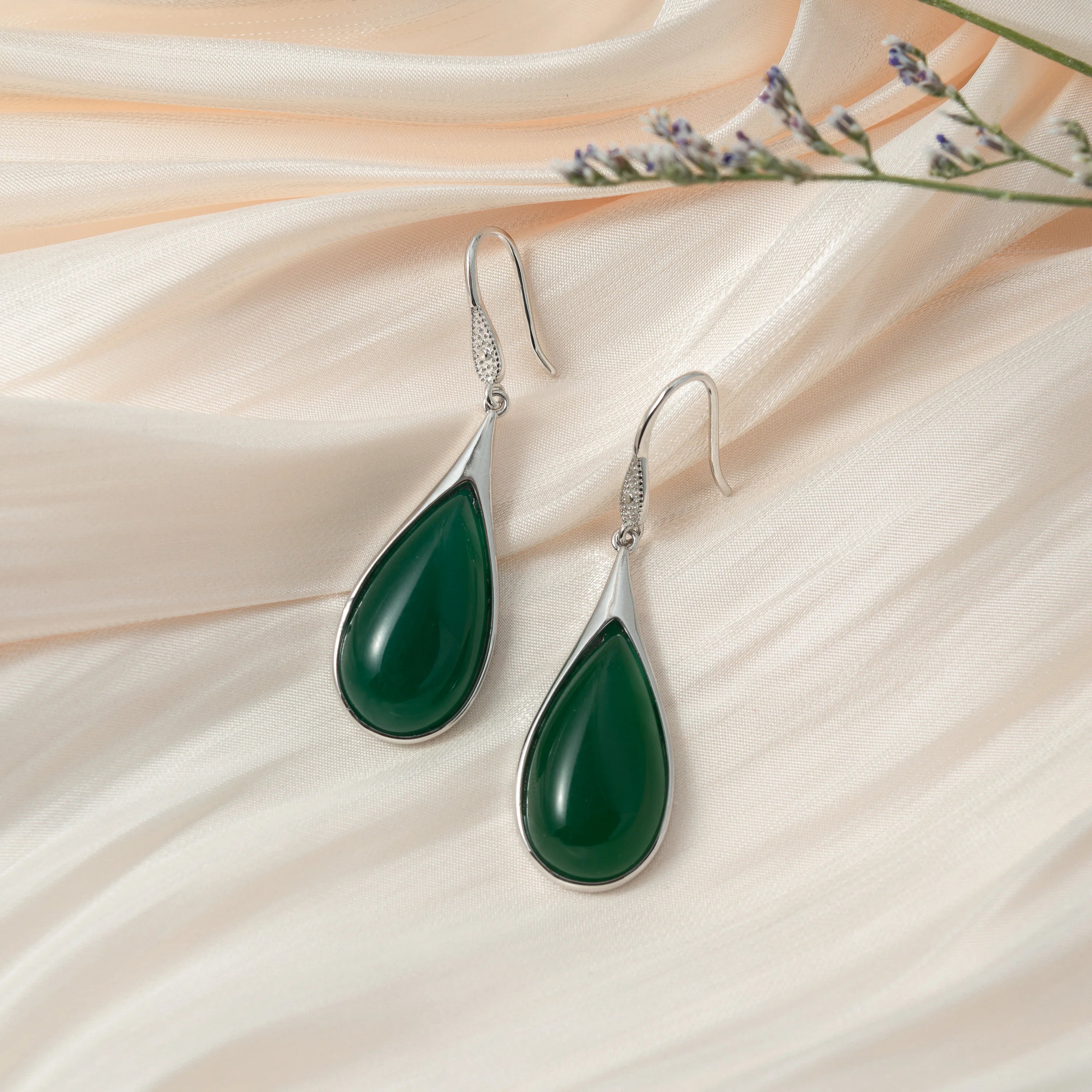 Vintage teardrop jade earrings handcrafted with sterling silver and natural Chinese jade on a silk cloth
