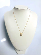 Model wearing dainty white jade necklace on gold-plated chain for scale