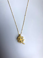 Back of white jade pendant showing smooth finish and gold loop