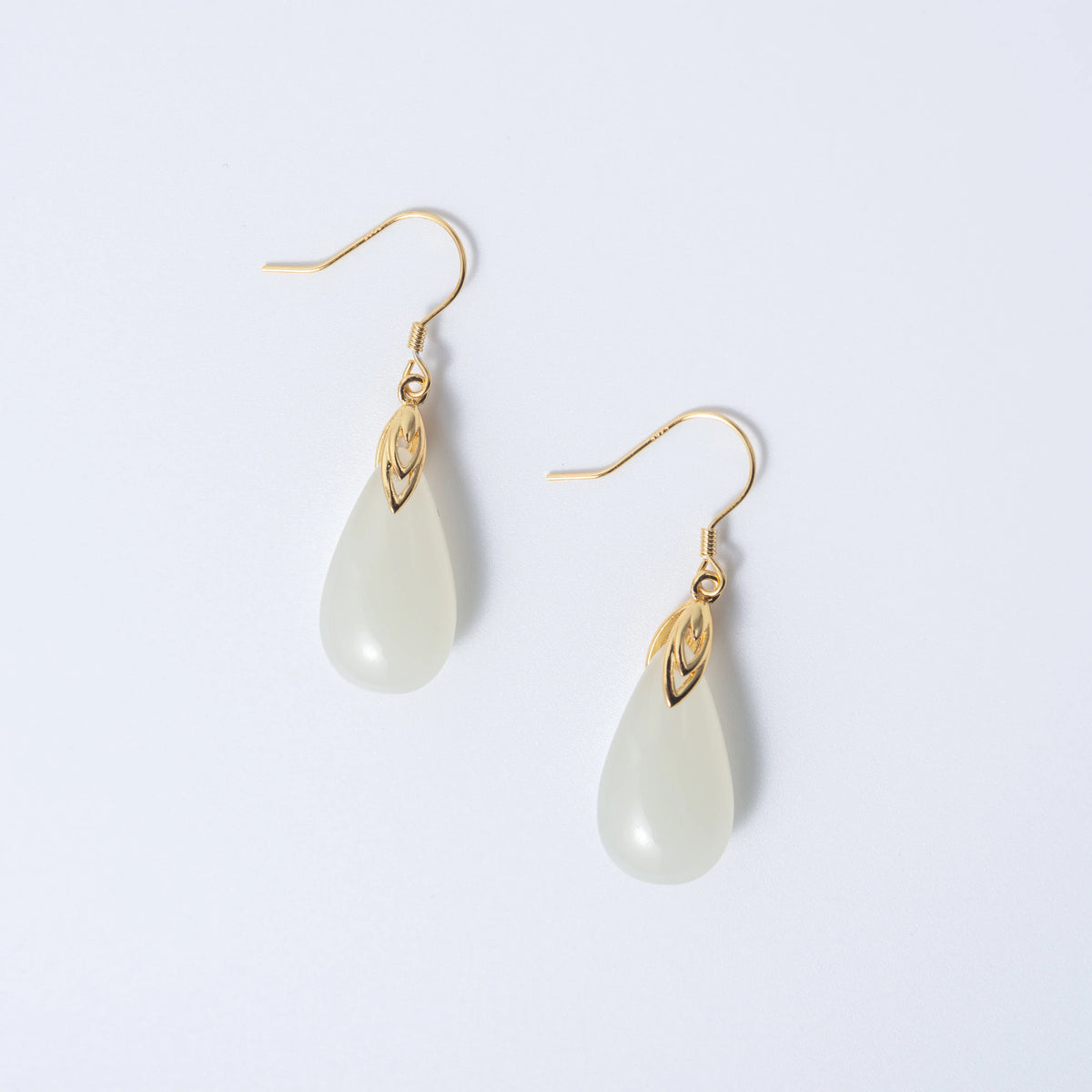 White teardrop jade earrings with soft natural finish and minimalist gold setting