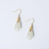 White teardrop jade earrings with soft natural finish and minimalist gold setting