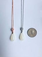 Size comparison of white jade teardrop necklace shown next to a US quarter coin