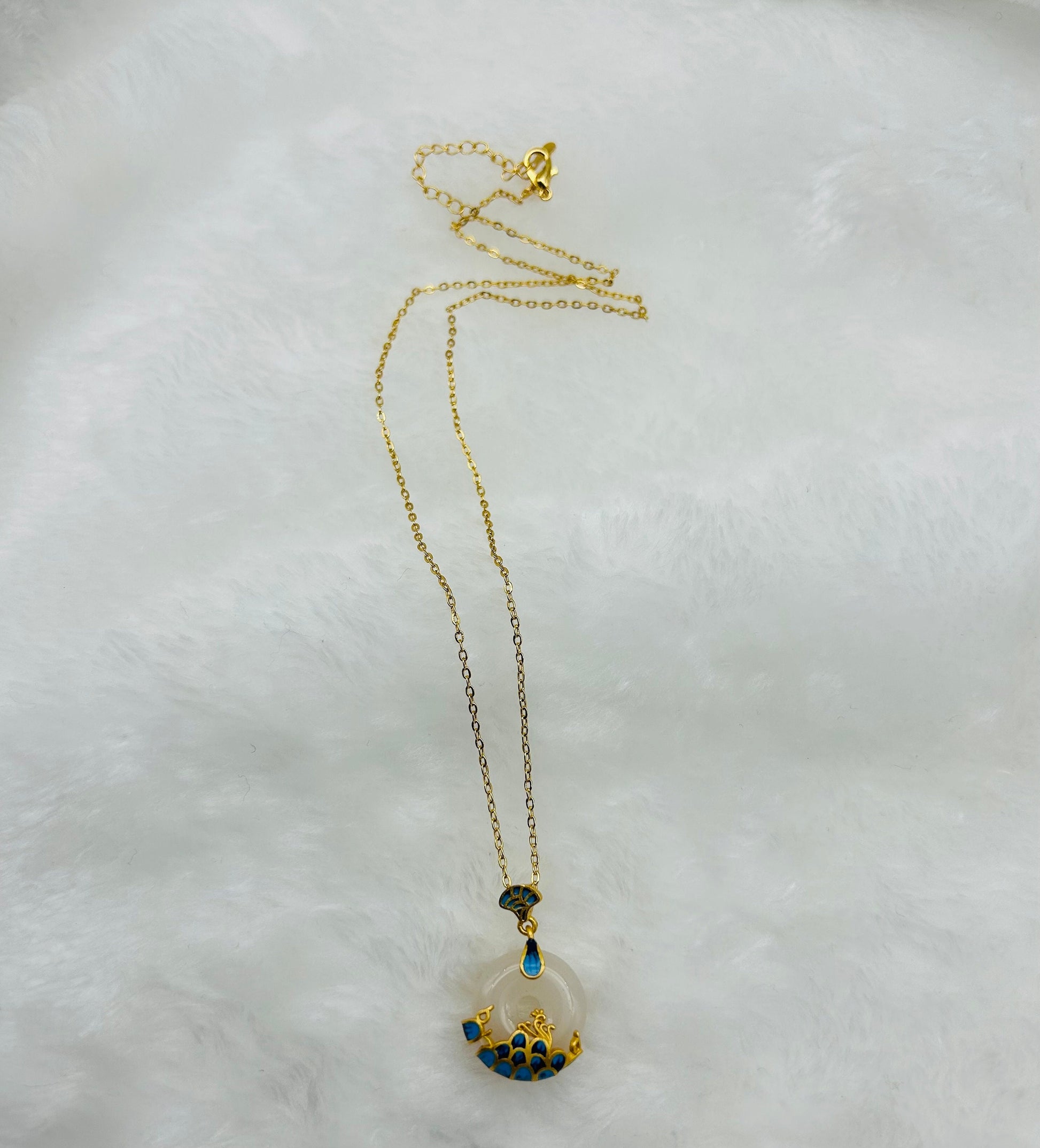 White jade ocean circle necklace displayed in elegant and soft cloth