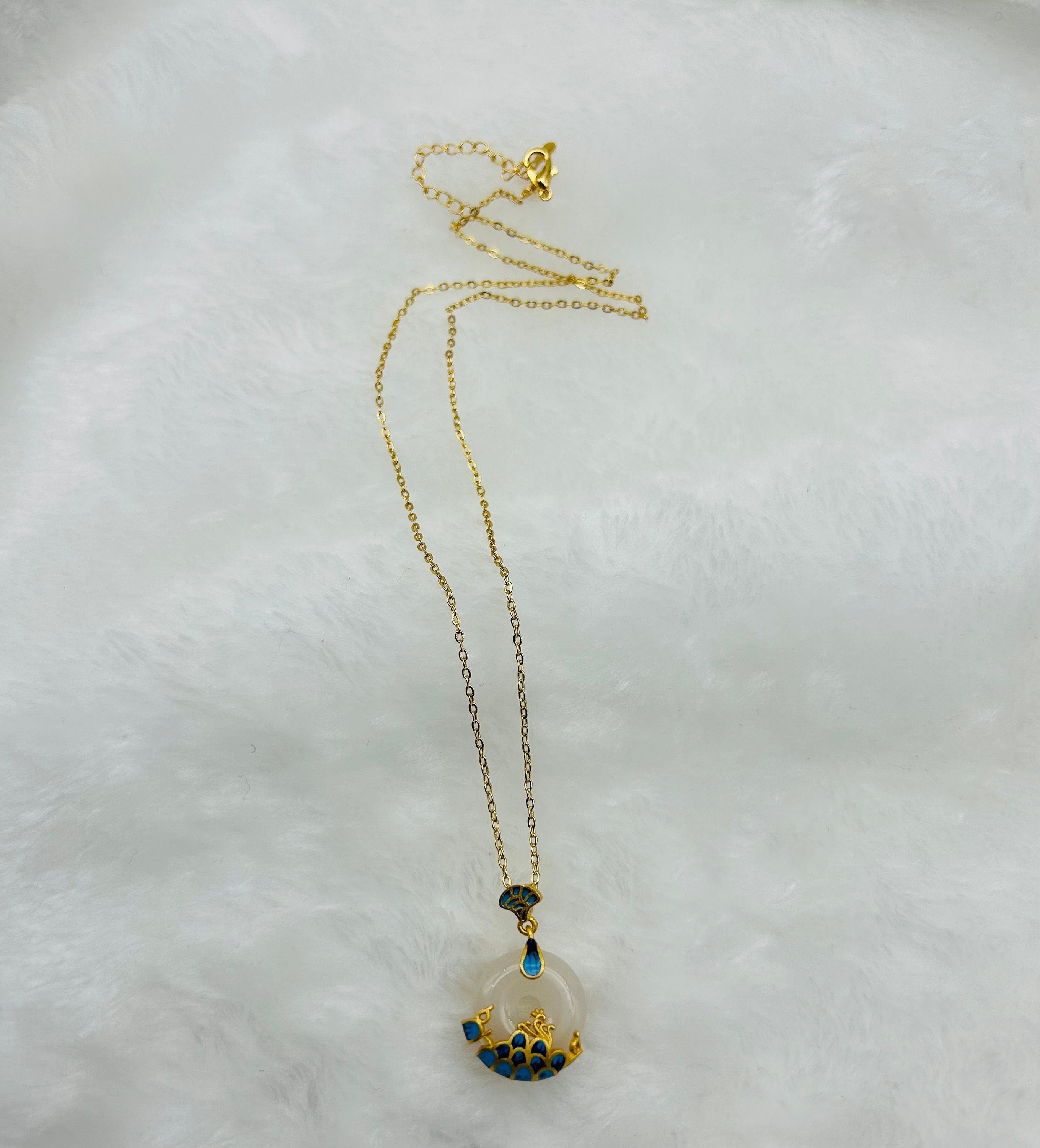 White jade ocean circle necklace displayed in elegant and soft cloth