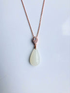 White jade pendant necklace with rose gold setting, modern and minimalist design, front view