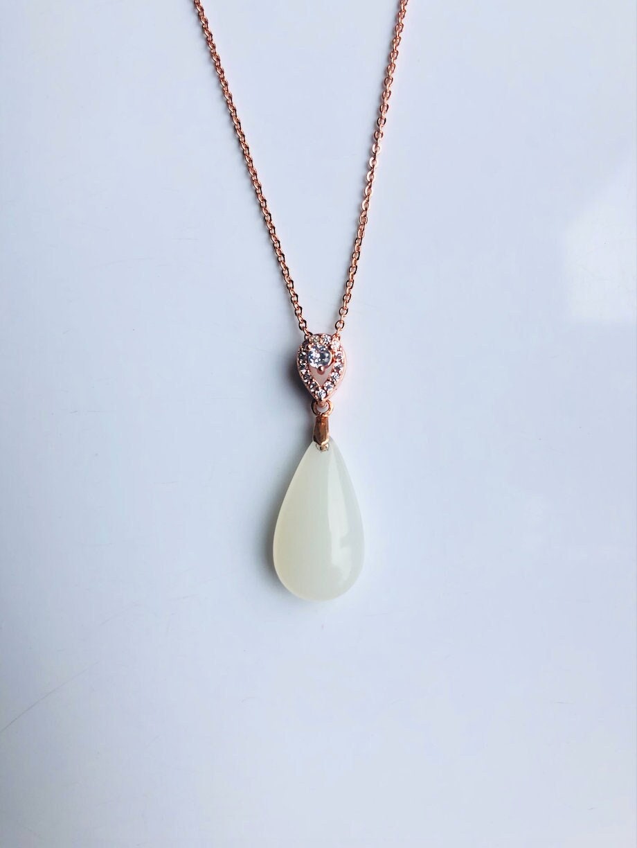White jade pendant necklace with rose gold setting, modern and minimalist design, front view