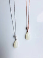 White jade pendant necklace with rose gold and silver setting, modern and minimalist design, in a pair