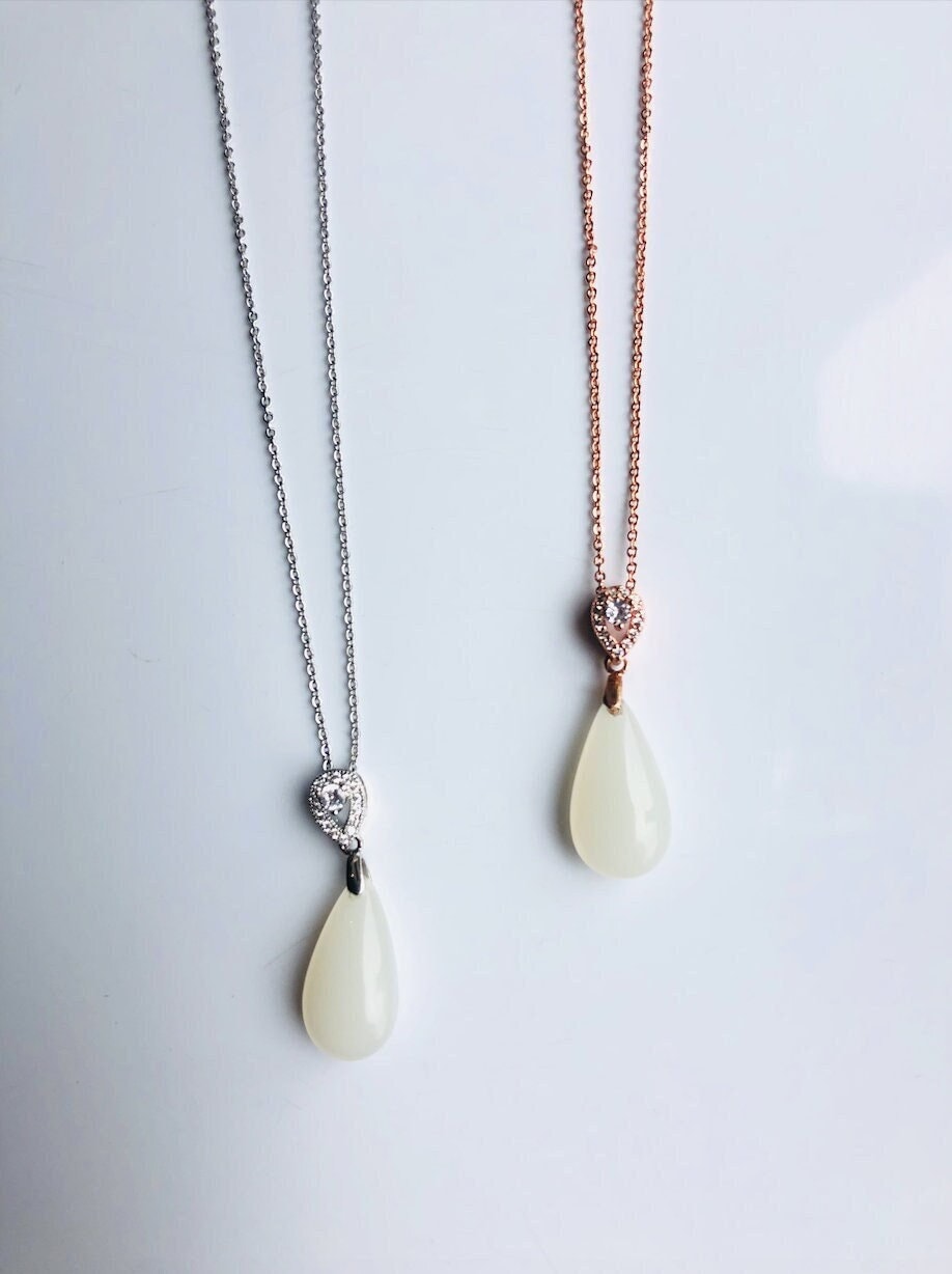 White jade pendant necklace with rose gold and silver setting, modern and minimalist design, in a pair