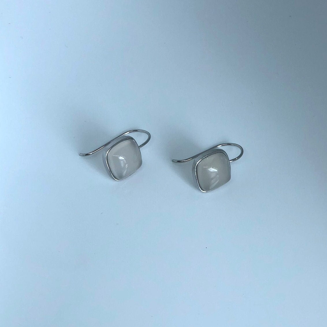 Front view of minimalist white jade square earrings with 990 sterling silver hooks