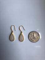 White jade earrings shown next to coin for teardrop size reference

