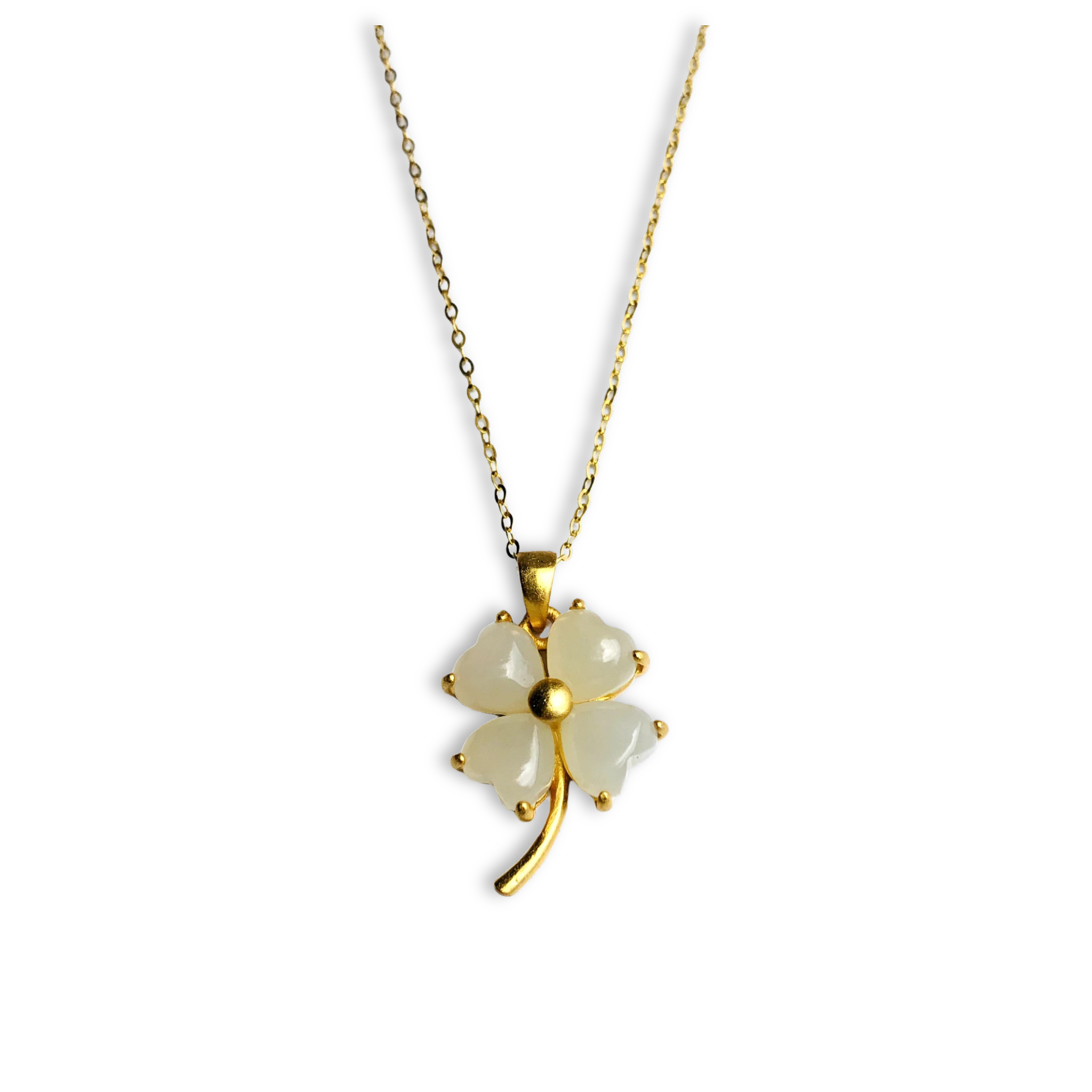 Gold necklace with a four-leaf clover pendant on a white background