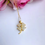 white jade clover pendant with pink rose background